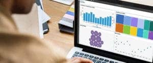 Man using IBM Planning Analytics on a laptop