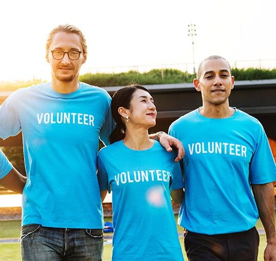 Not-for-profit industry: Four volunteers in blue shirts