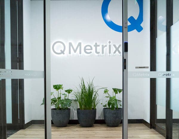 QMetrix office entrance with logo and plants