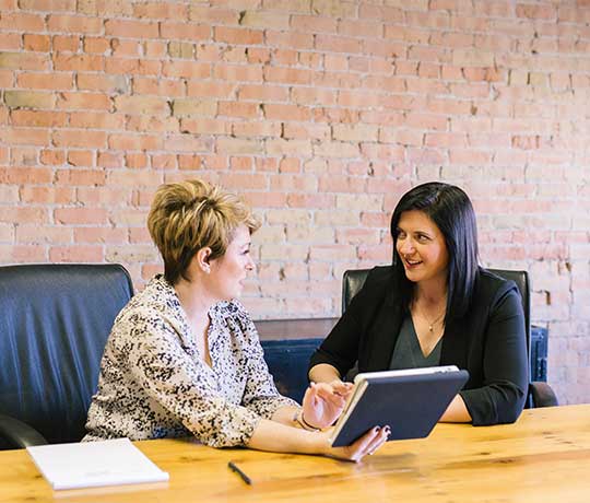 Technology 1 Two business women having a meeting with a tablet