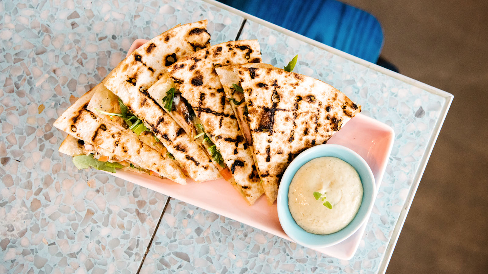 Grilled flatbread slices arranged on a pink rectangular plate