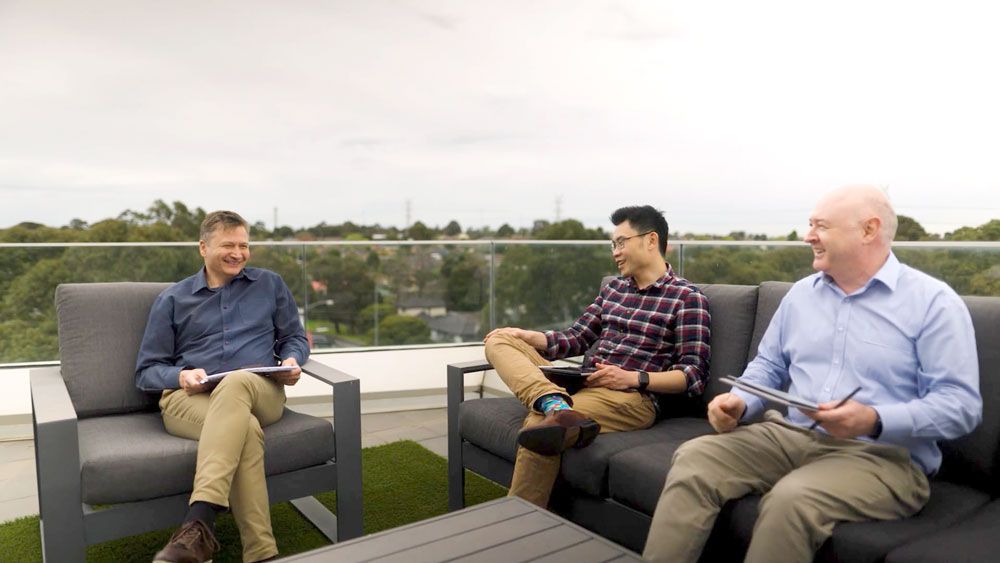 QMetrix directors having a chat at the office balcony