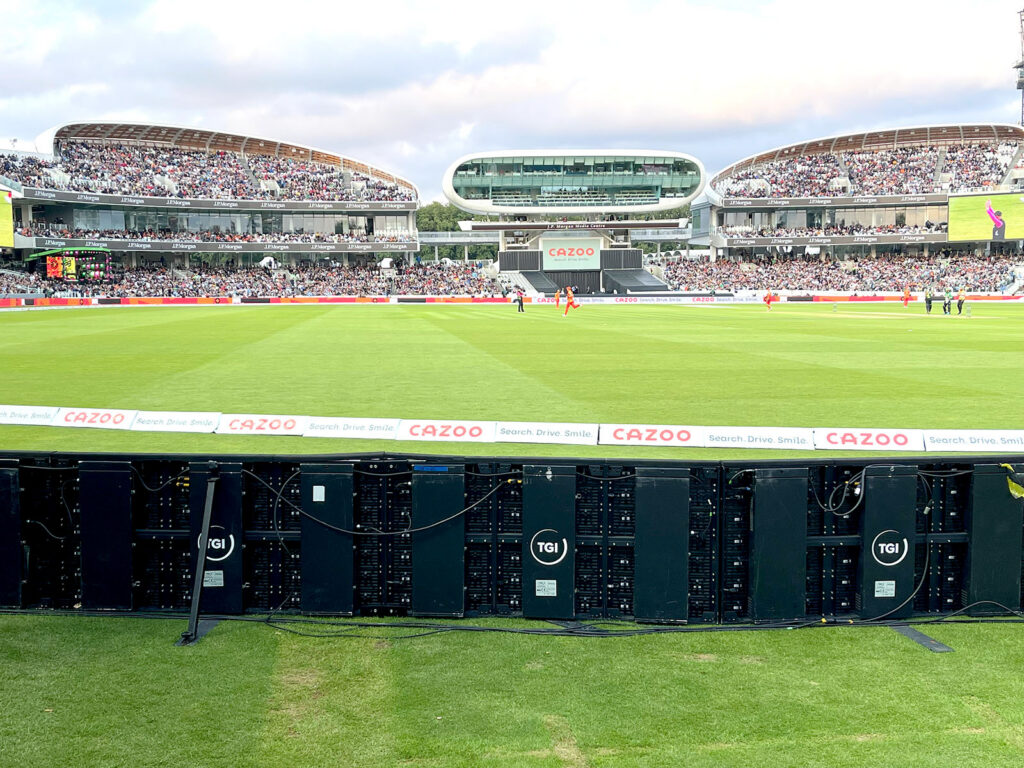 A cricket stadium with electronic advertising on TGI Sport boards