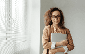 Professional woman standing by window
