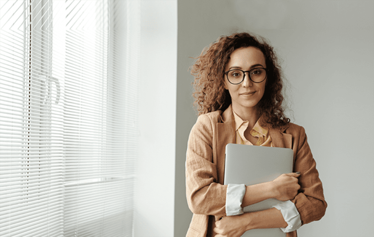 Professional woman standing by window