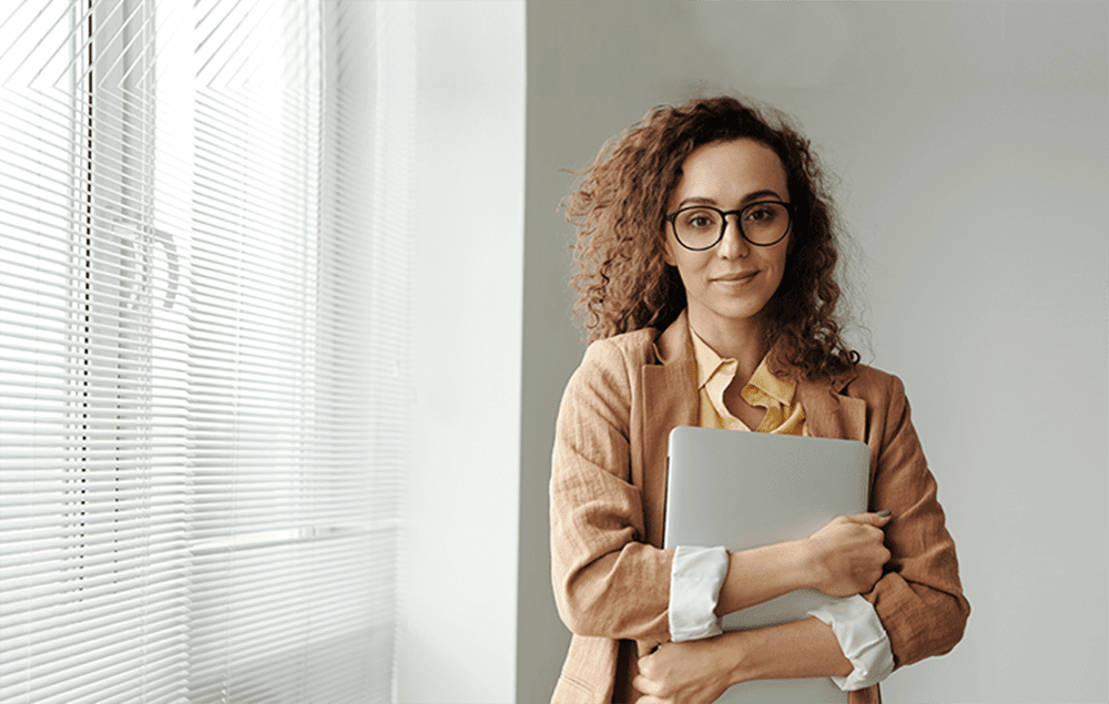 Professional woman standing by window