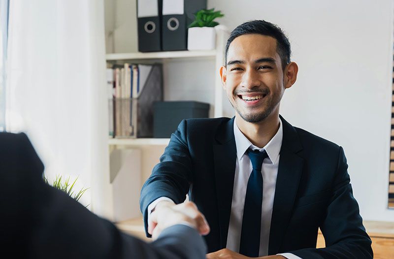 young-businessman-handshake-smiling