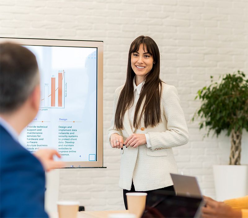 businesswoman giving presentation in bright office