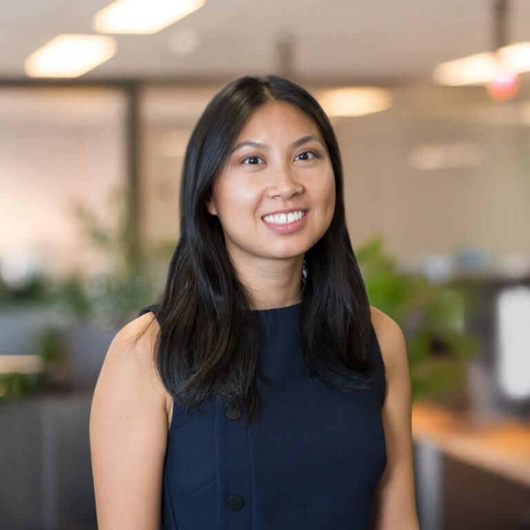 Joanne Thien, a woman with long dark hair wearing a sleeveless navy top.